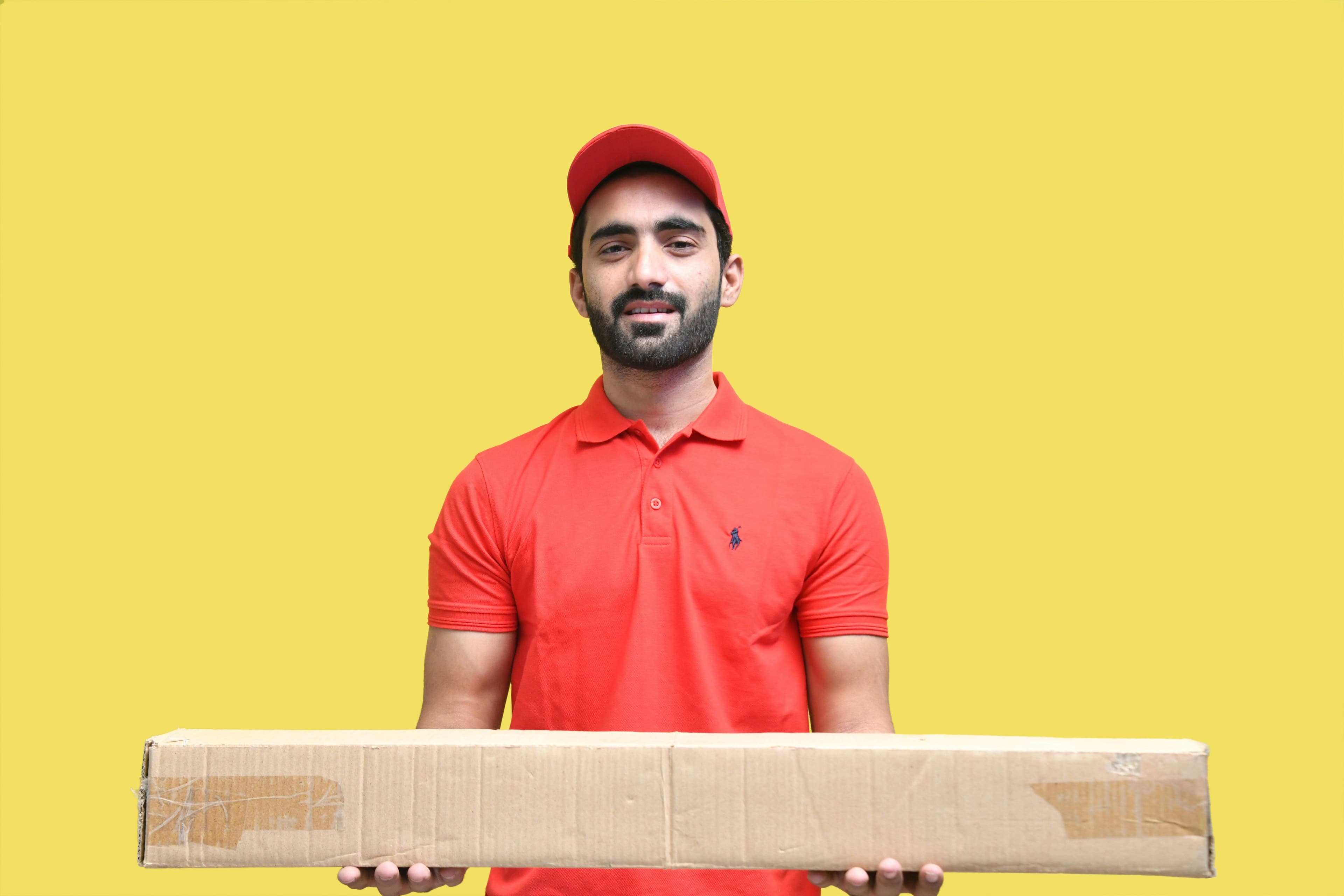 A courier holding out a package for delivery